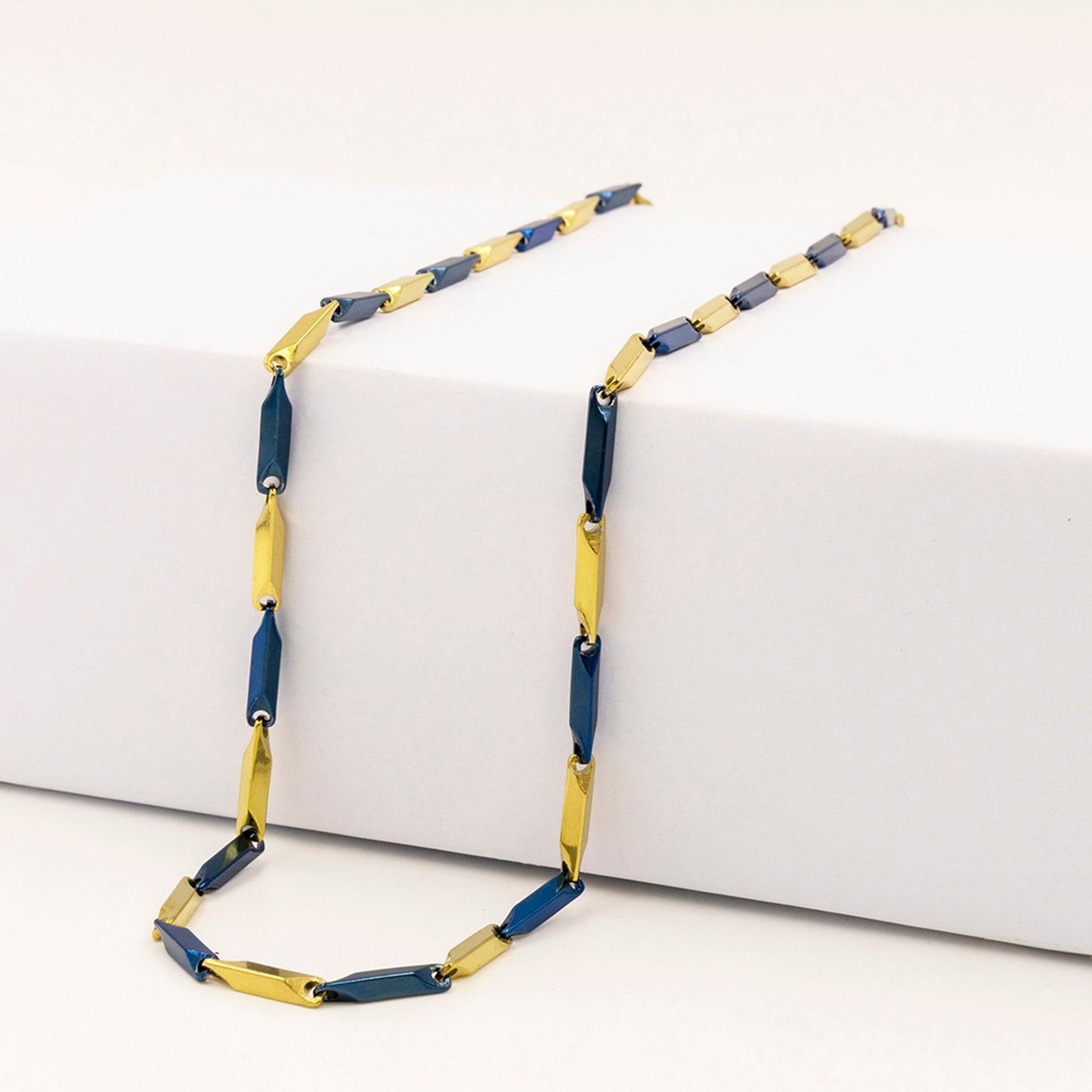 Emberstone Jewellery men's stainless steel necklace with a stylish rice chain design in blue and gold