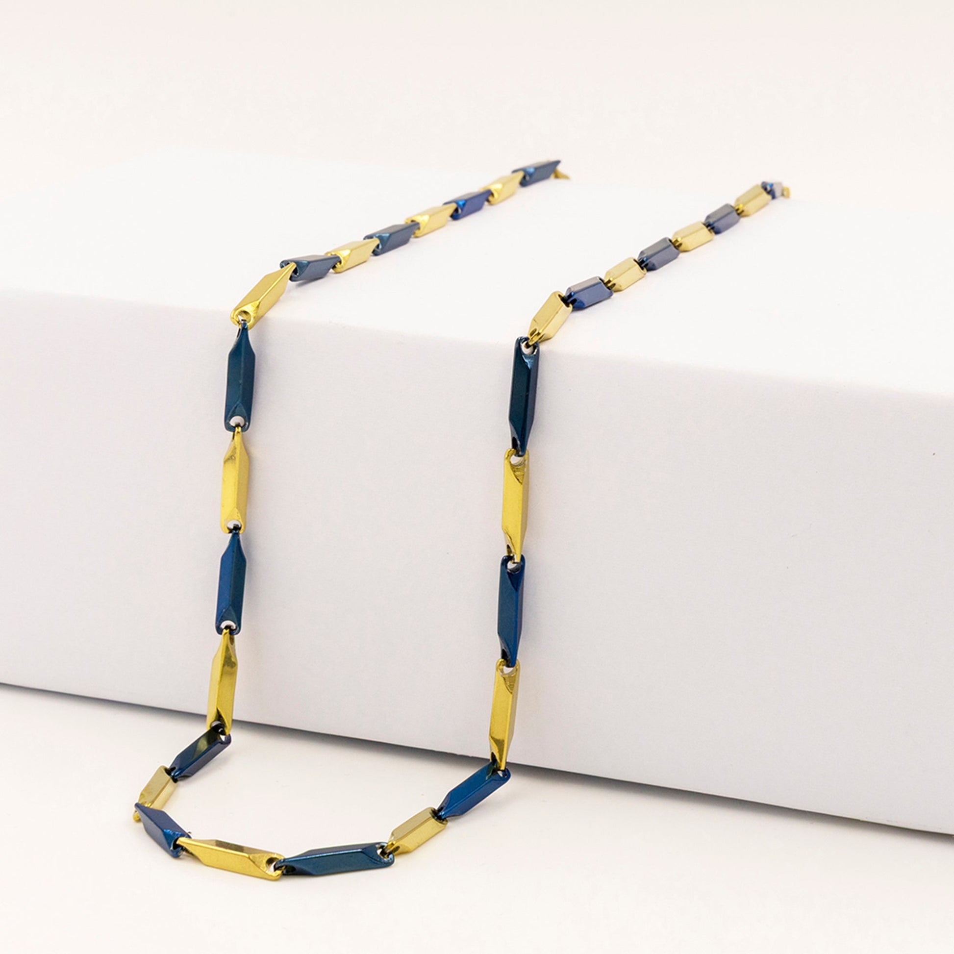 Emberstone Jewellery men's stainless steel necklace with a stylish rice chain design in blue and gold