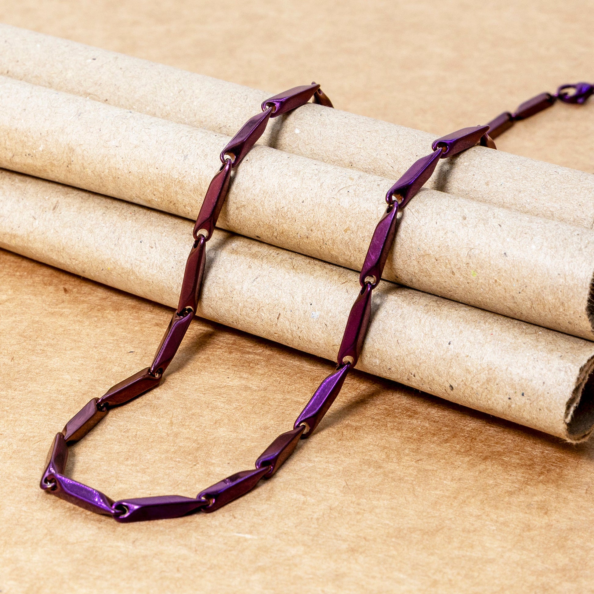 Men's stainless steel necklace with a unique rice chain design in purple and brown tones